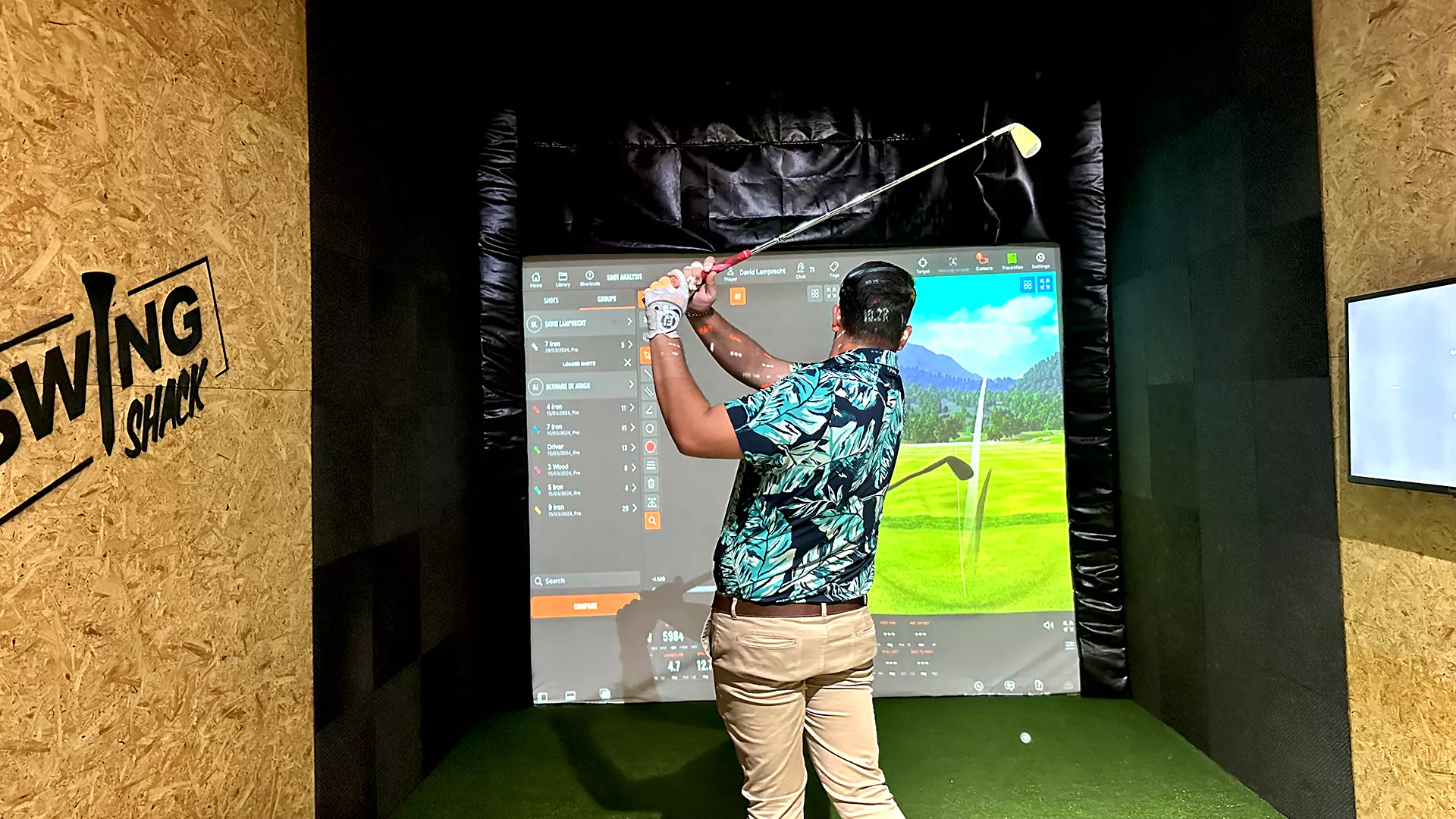 Golfer playing indoors on trackman simulators